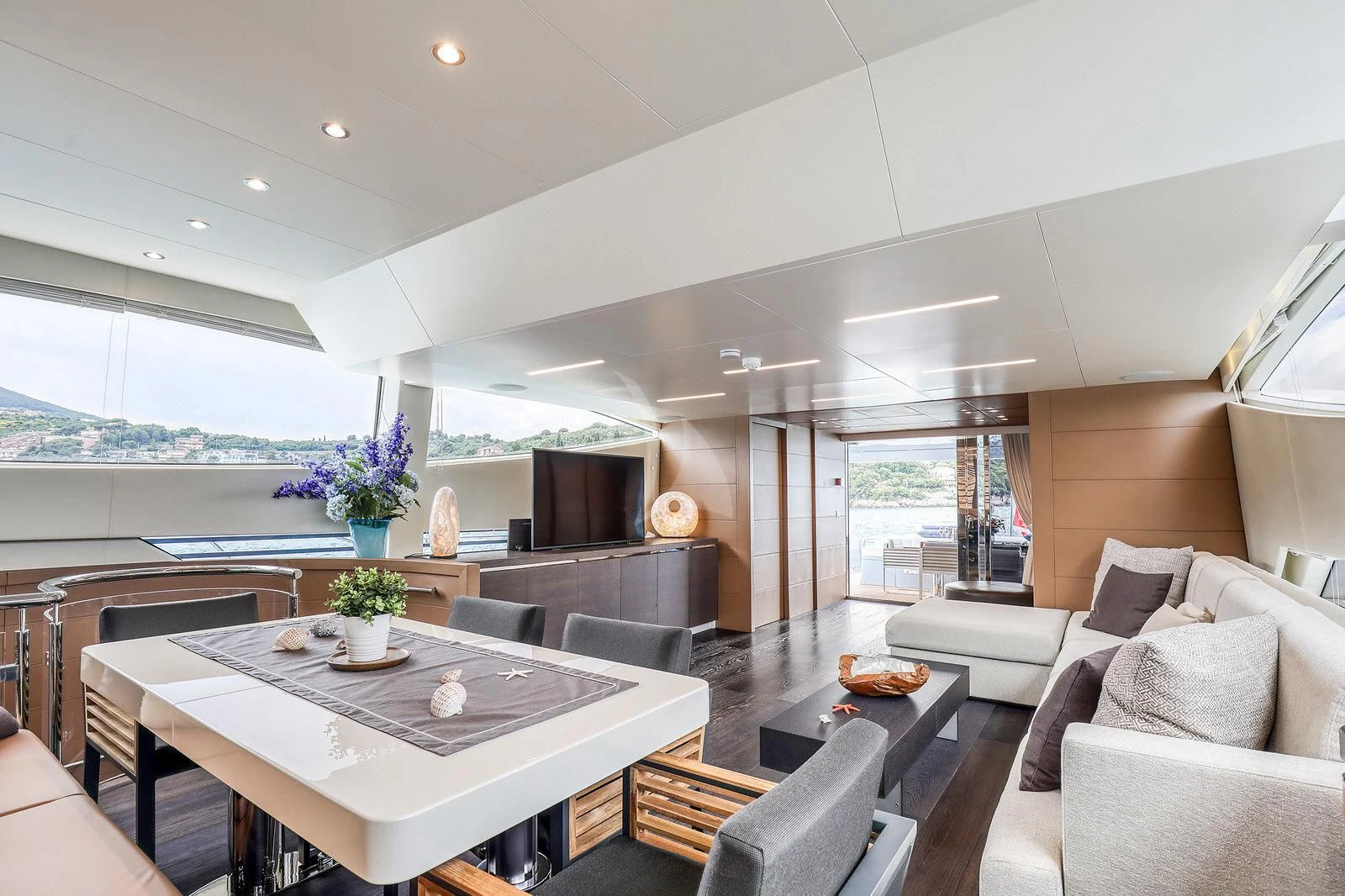 a living room with a table and couches aboard 55 FIFTYFIVE Yacht for Charter