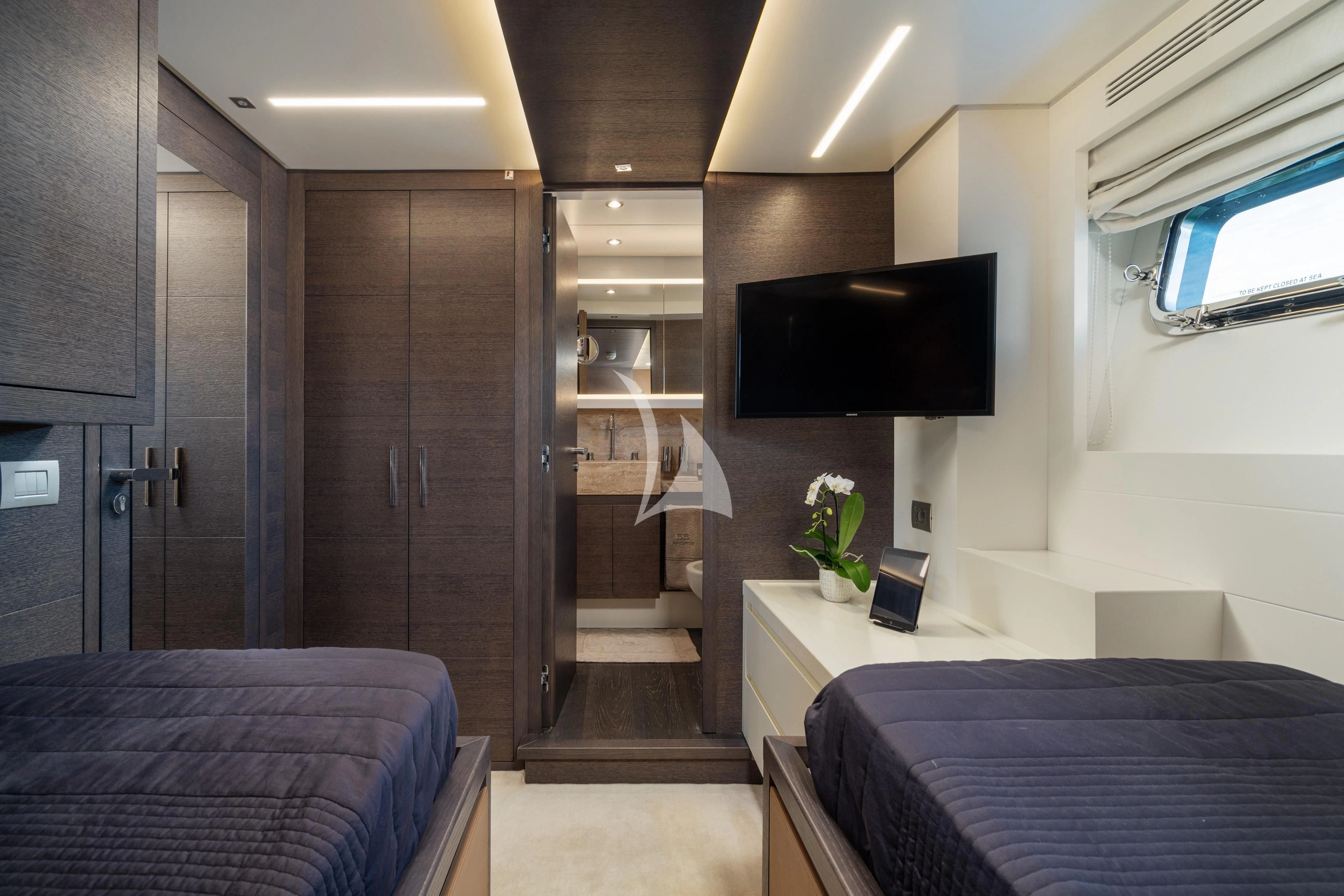 a bedroom with a bed and a tv aboard 55 FIFTYFIVE Yacht for Charter