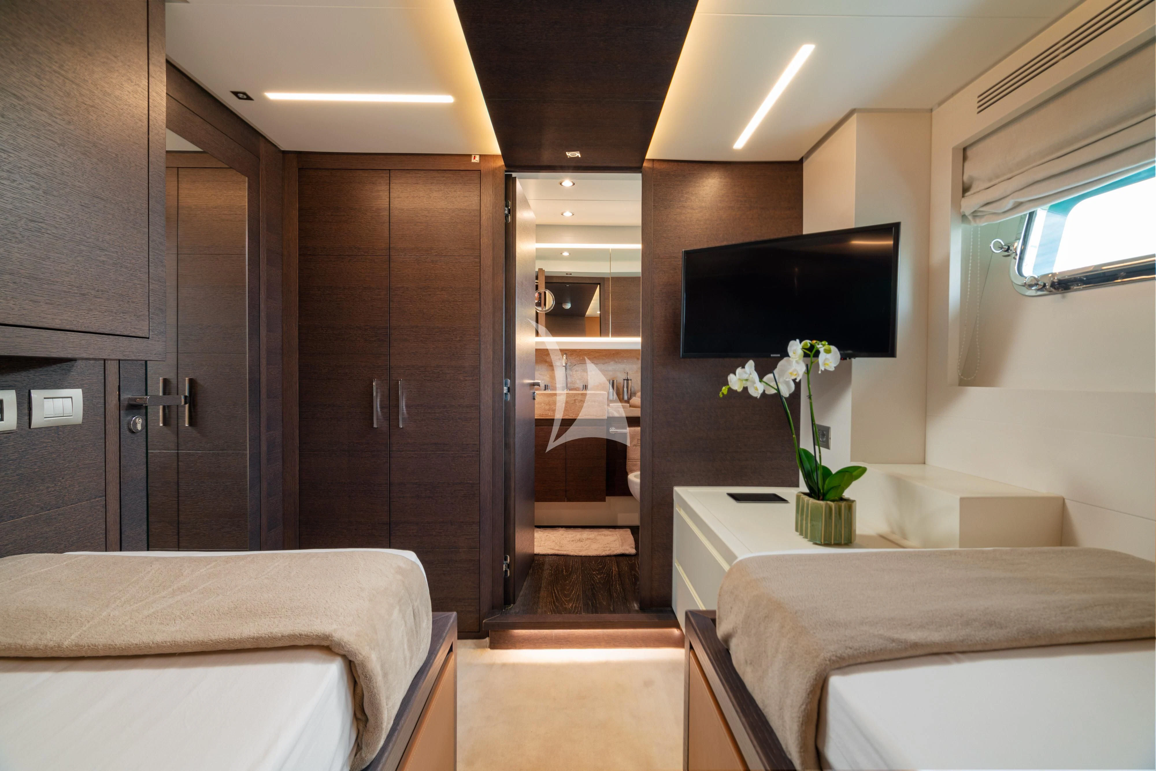 a room with a bed and a tv aboard 55 FIFTYFIVE Yacht for Charter