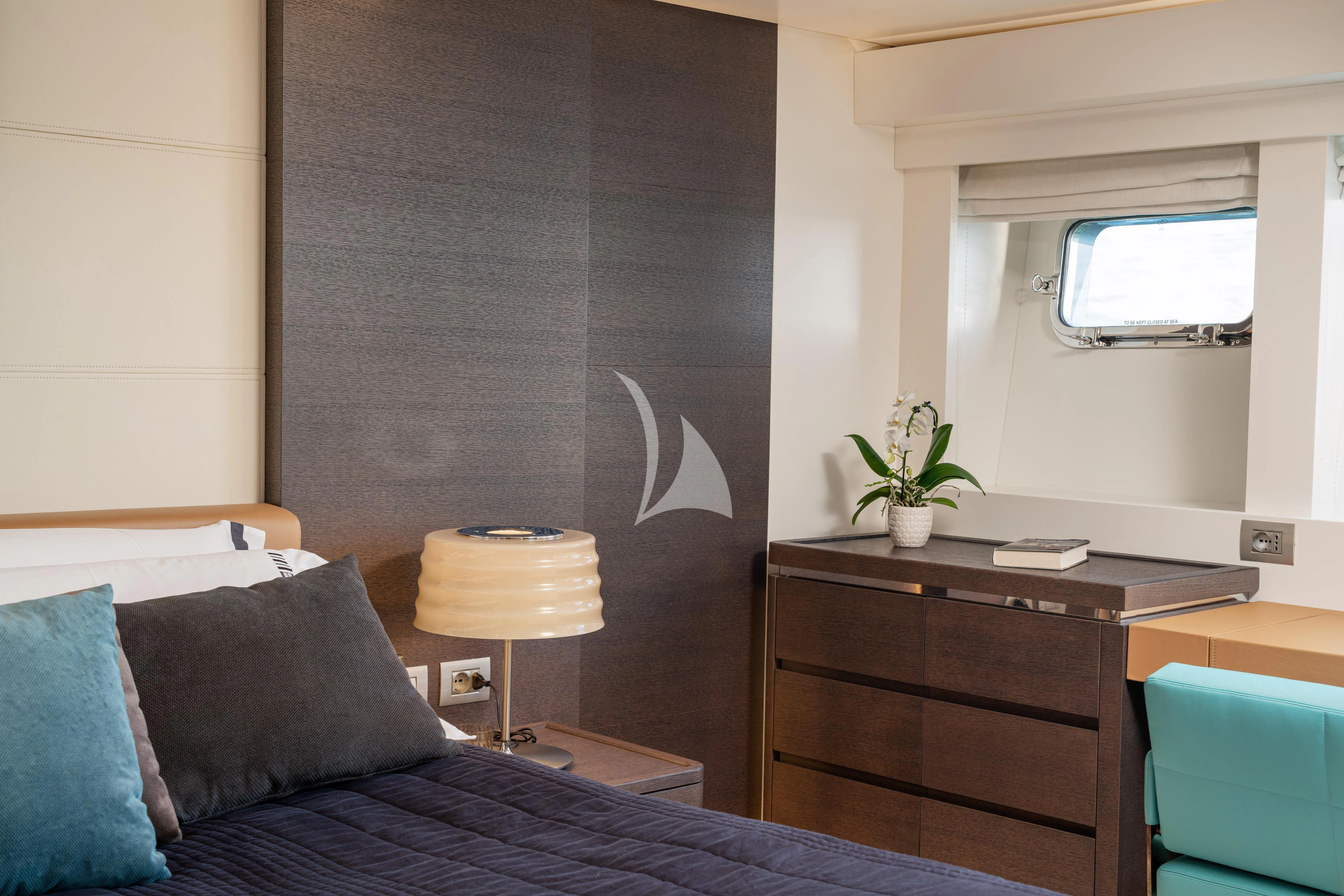 a bedroom with a bed and a desk aboard 55 FIFTYFIVE Yacht for Charter