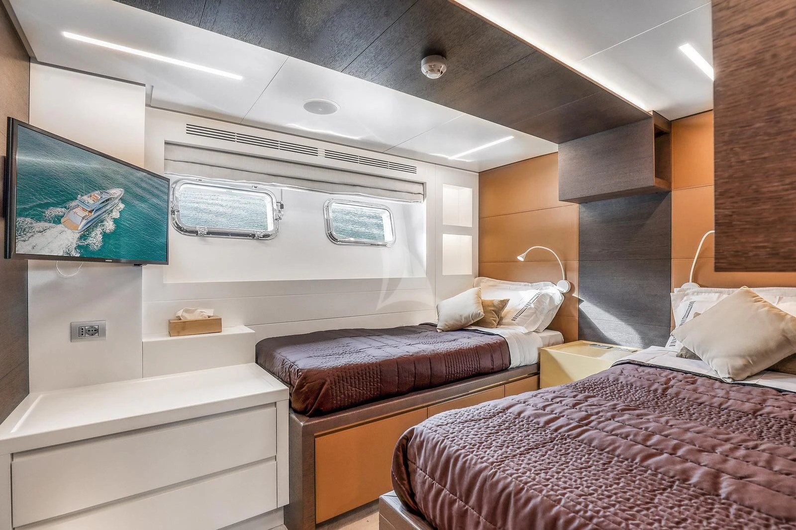 a room with beds and a window aboard 55 FIFTYFIVE Yacht for Charter