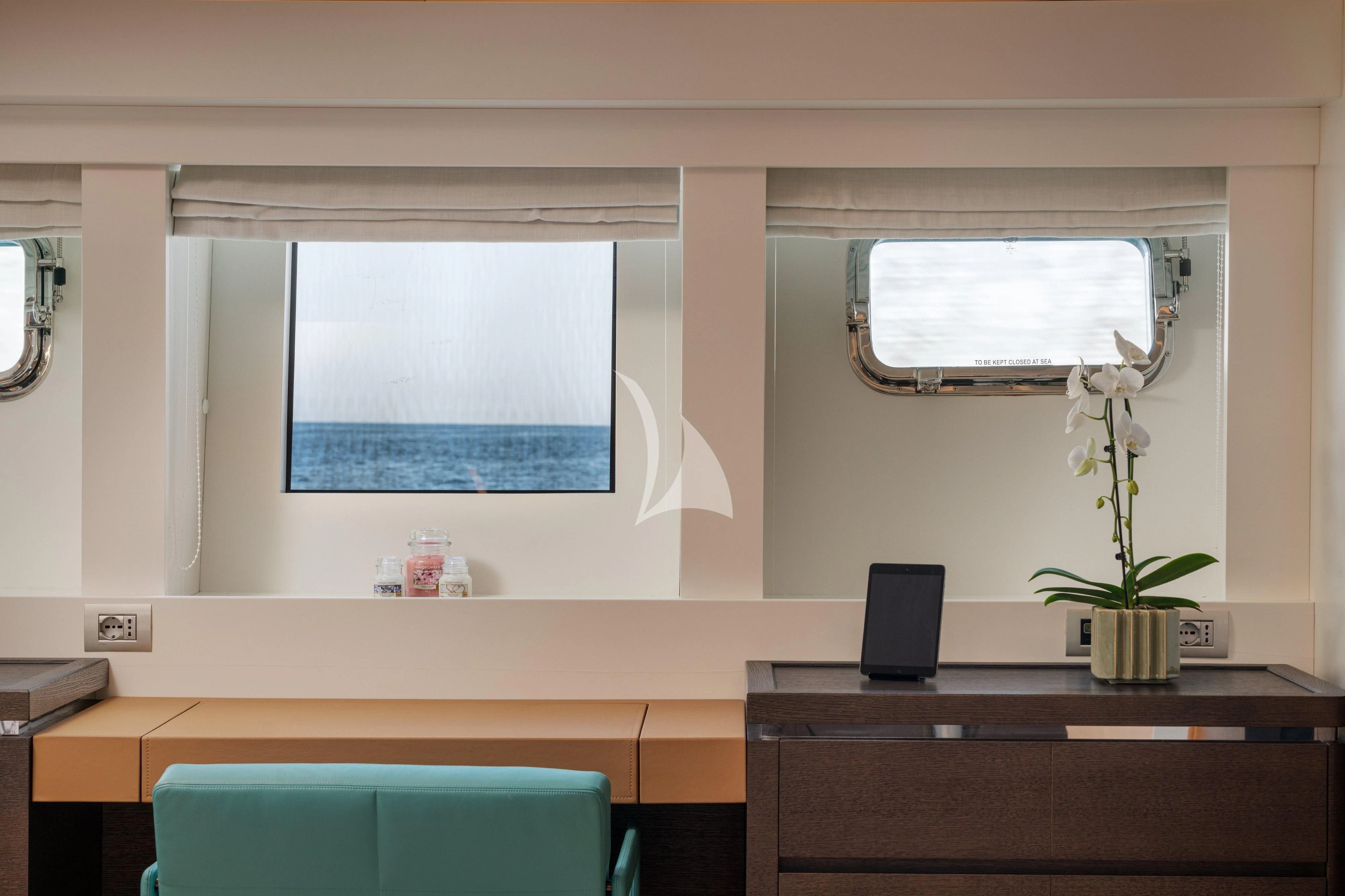 a room with a desk and a window aboard 55 FIFTYFIVE Yacht for Charter