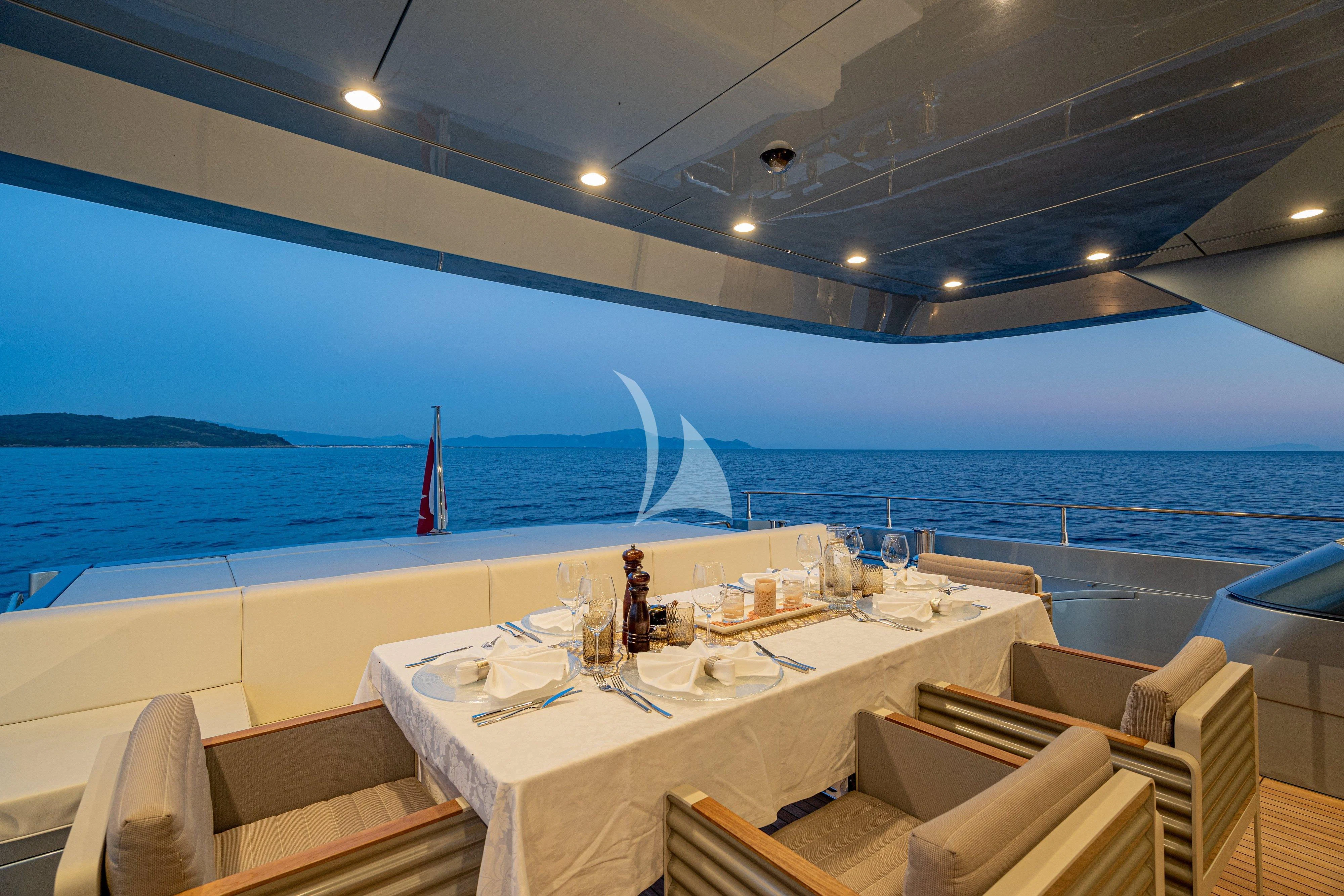 a room with tables and chairs and a view of the ocean aboard 55 FIFTYFIVE Yacht for Charter