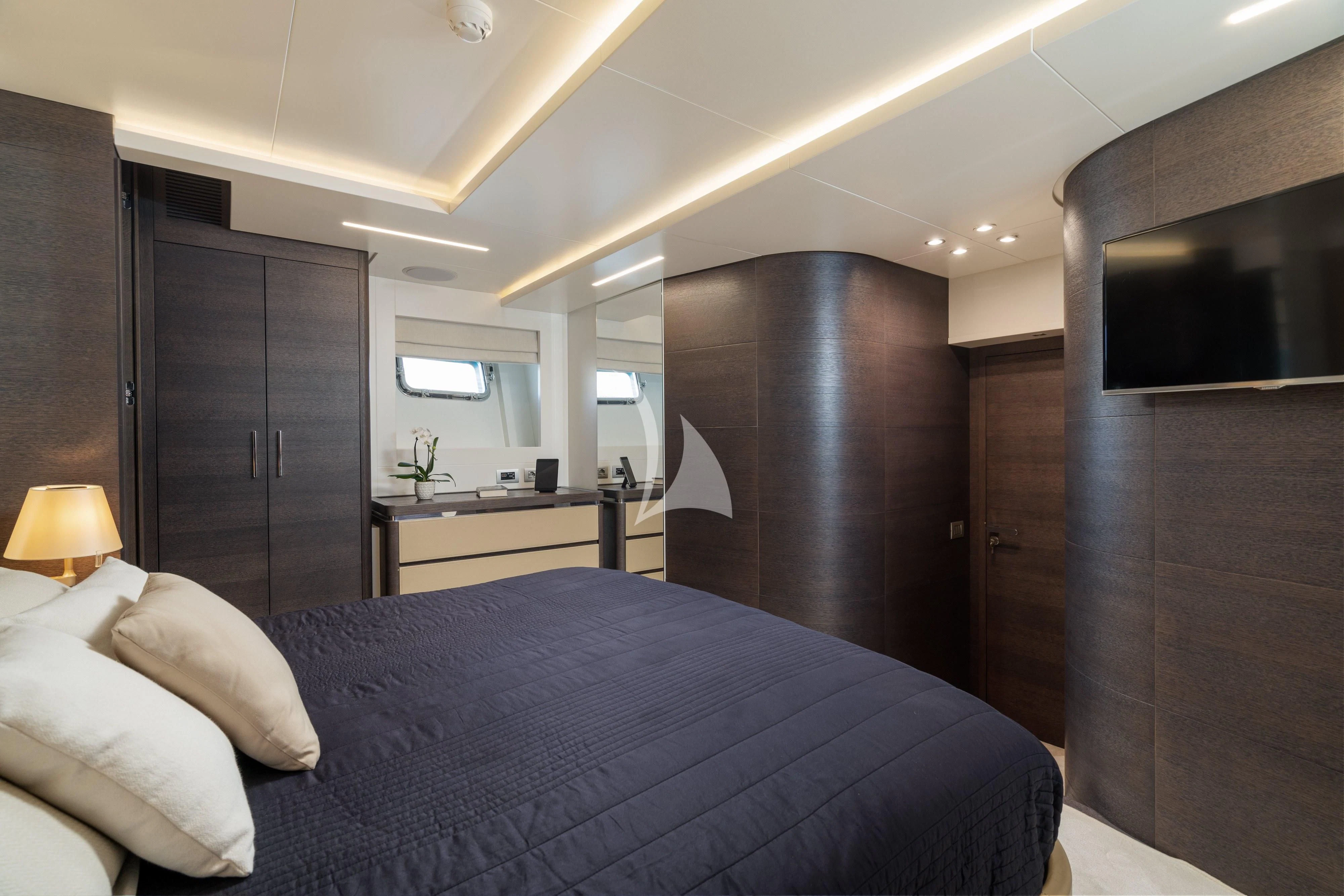a bedroom with a bed and a desk aboard 55 FIFTYFIVE Yacht for Charter