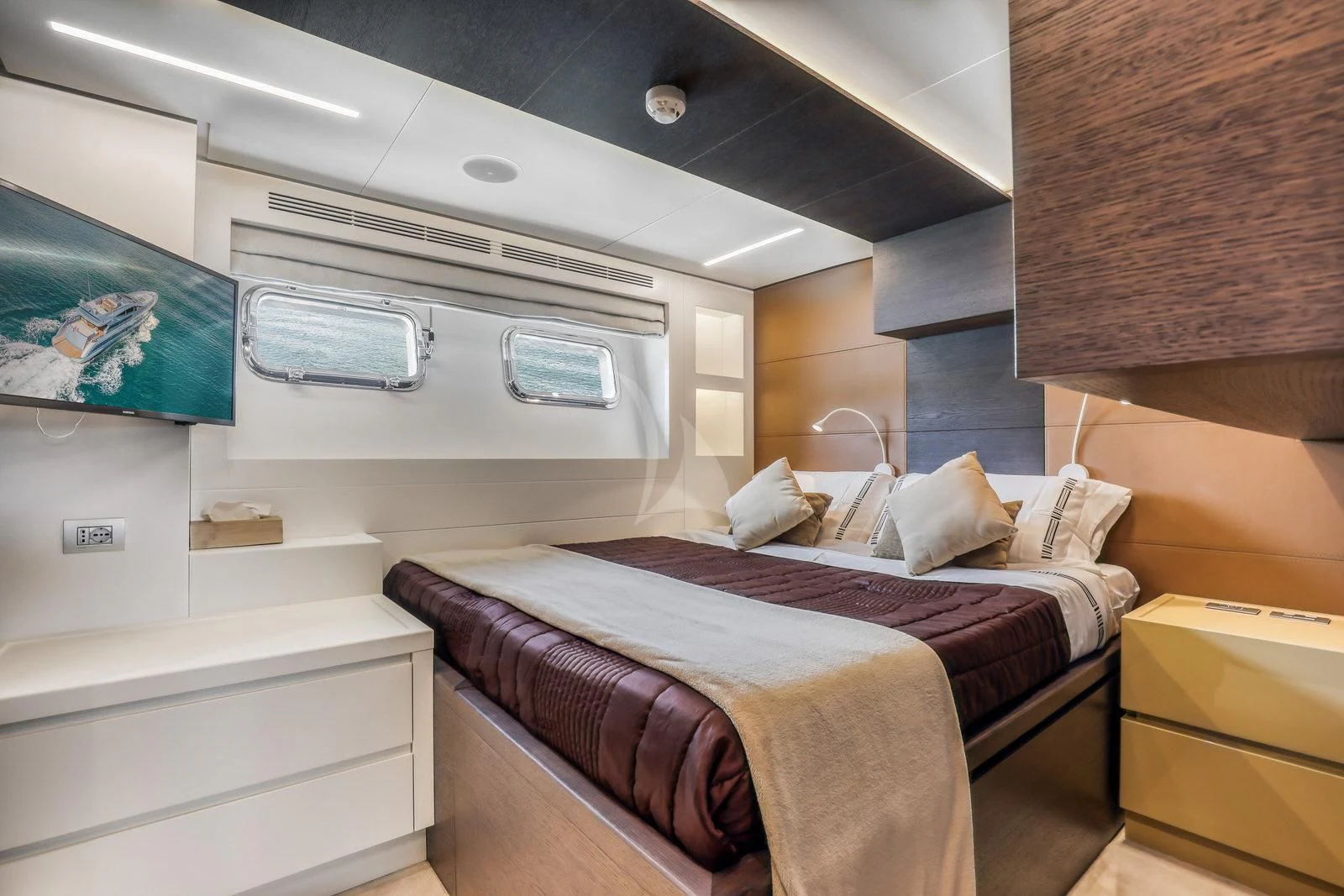 a room with a bed and a dresser aboard 55 FIFTYFIVE Yacht for Charter