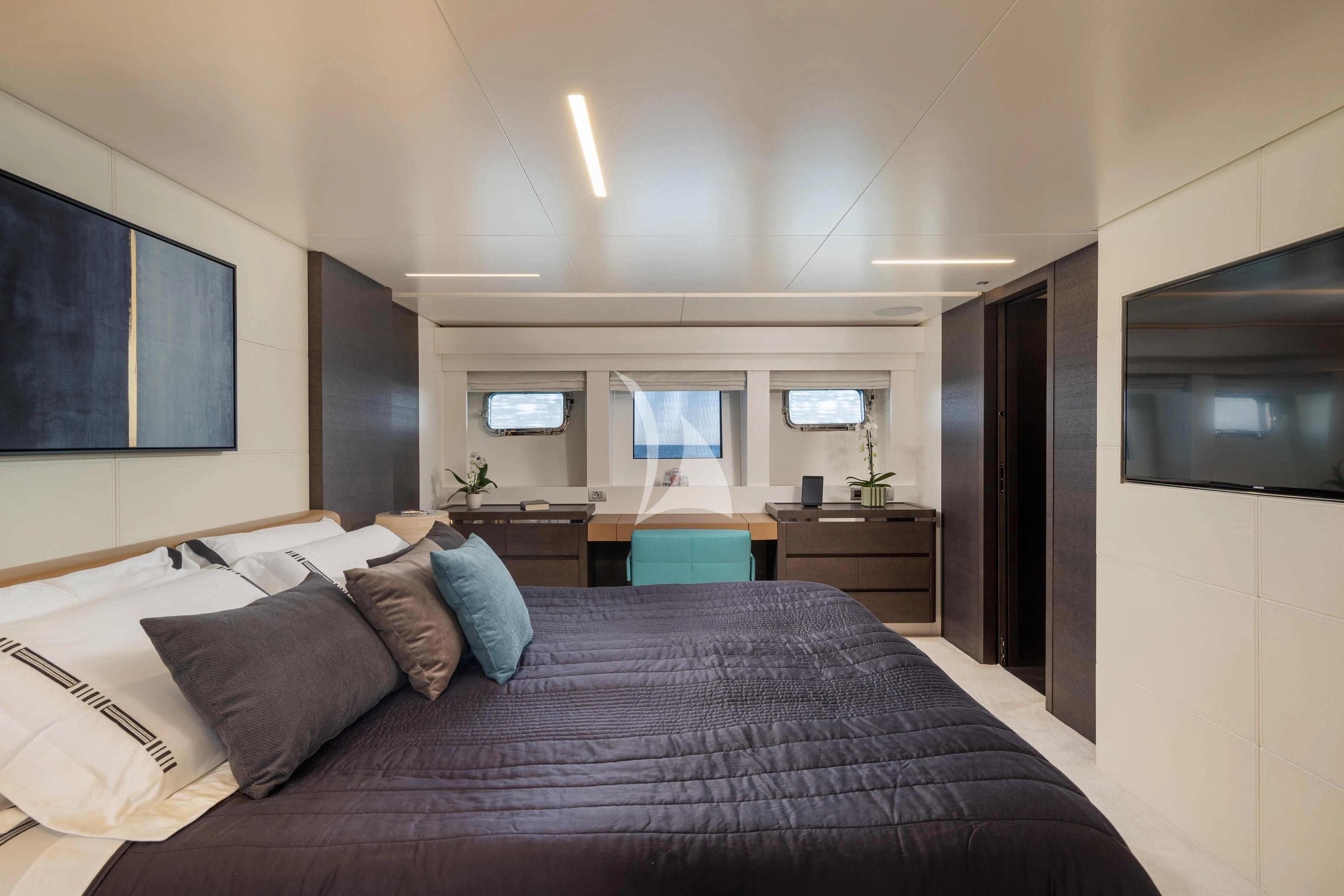 a bed with a blue blanket aboard 55 FIFTYFIVE Yacht for Charter