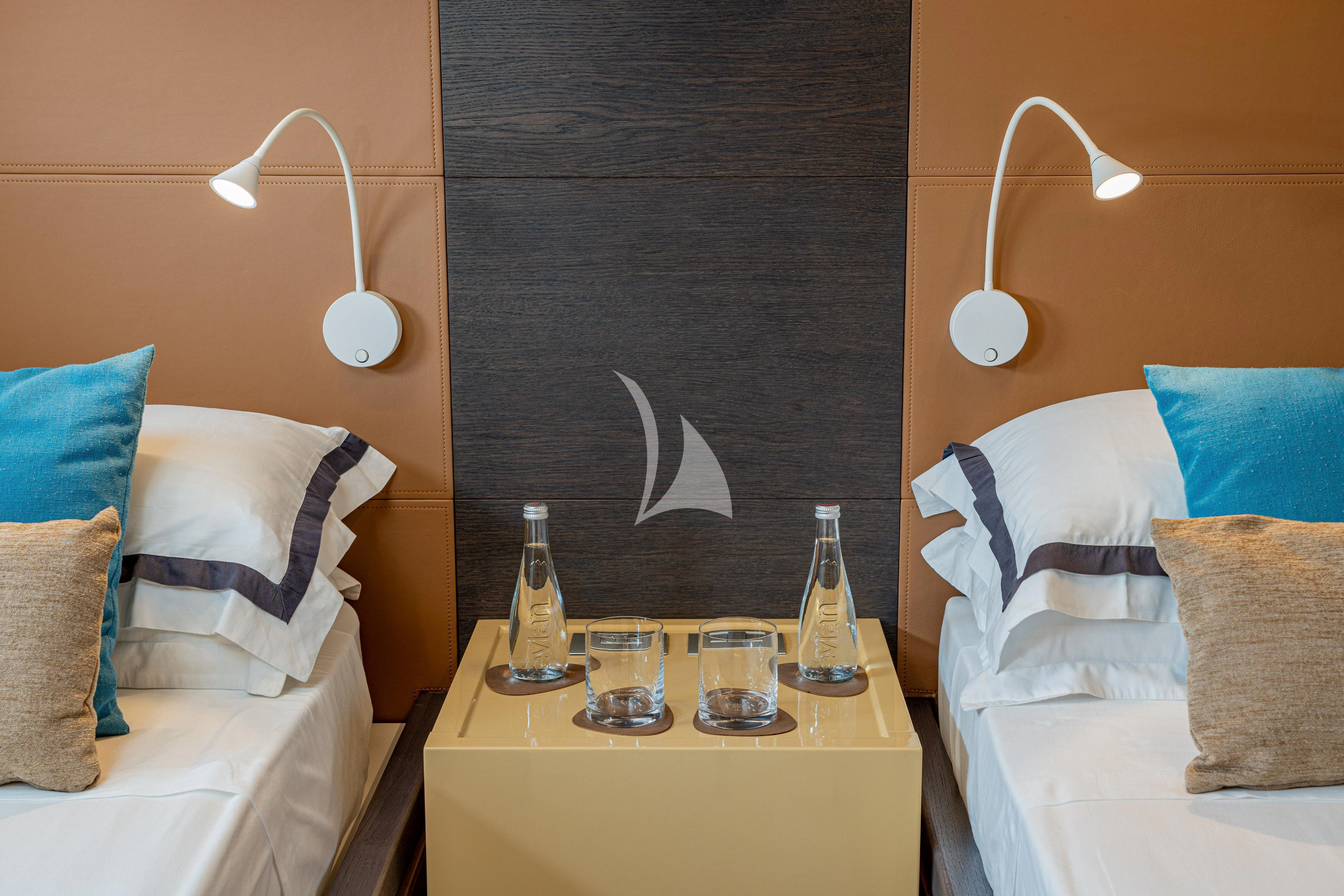 a room with a bed and a table with bottles on it aboard 55 FIFTYFIVE Yacht for Charter