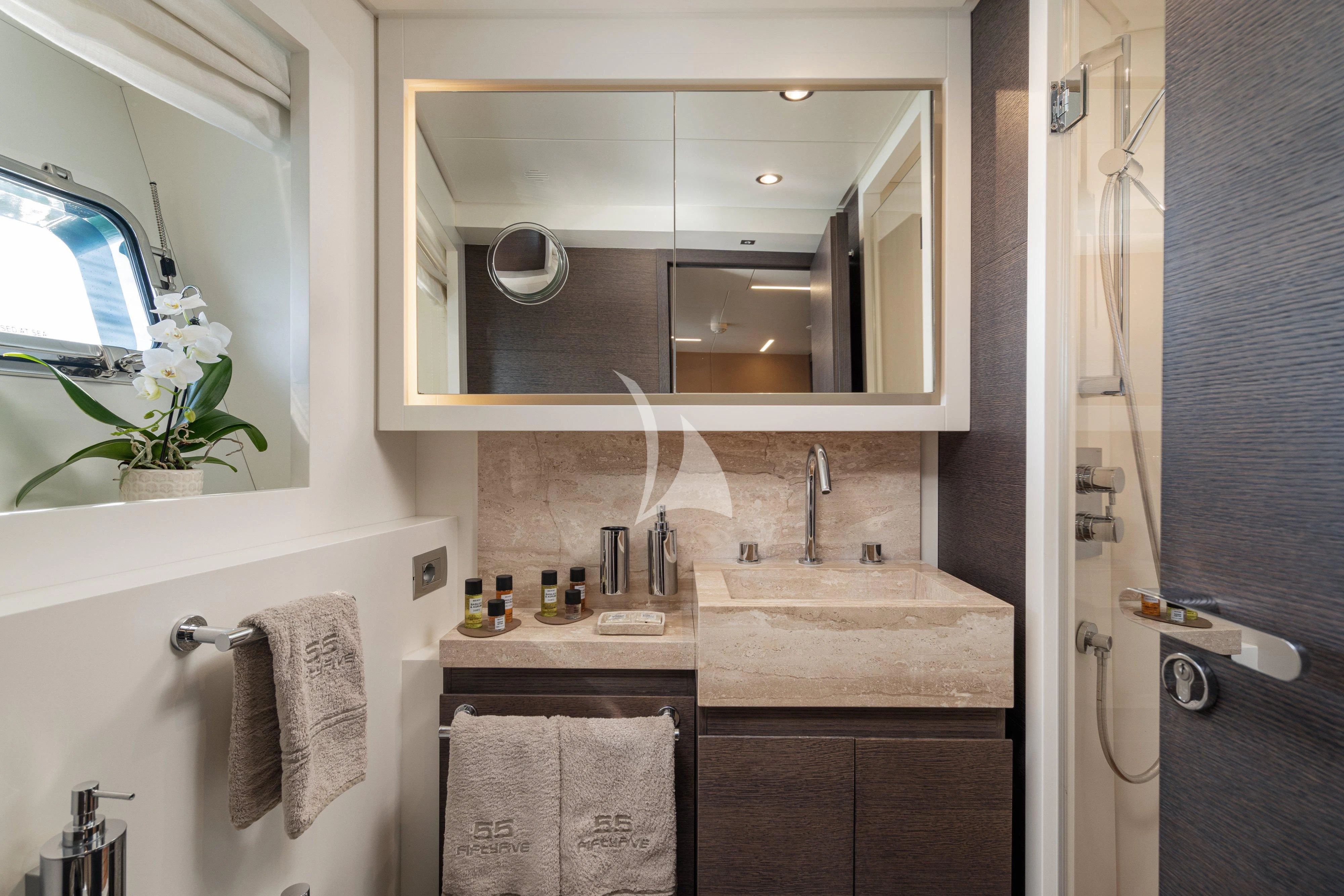 a bathroom with a mirror and sink aboard 55 FIFTYFIVE Yacht for Charter