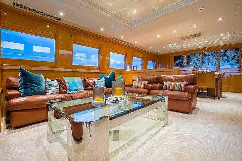 a living room with a table and couches aboard AKIM Yacht for Sale