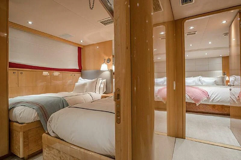 a room with a bed and a mirror aboard AKIM Yacht for Sale