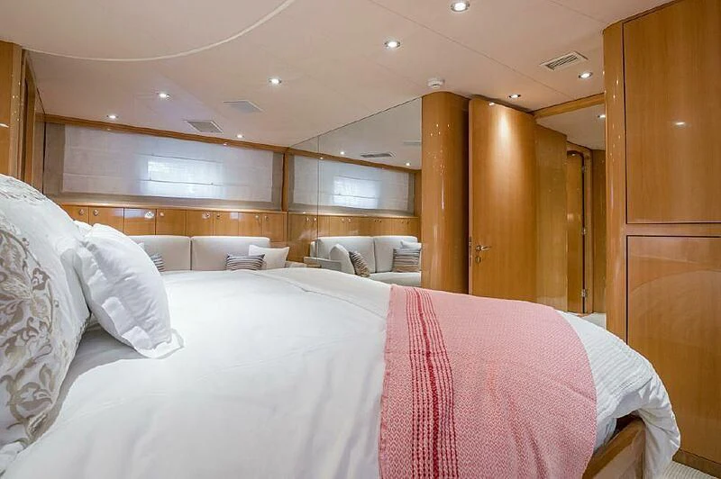 a room with a bed and a chair aboard AKIM Yacht for Sale