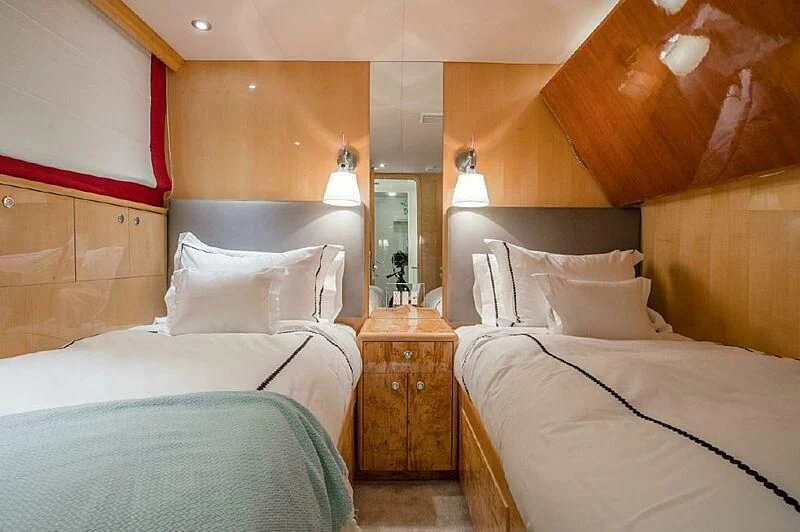 a room with beds and a mirror aboard AKIM Yacht for Sale