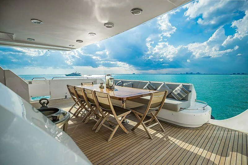 a table and chairs on a deck aboard AKIM Yacht for Sale