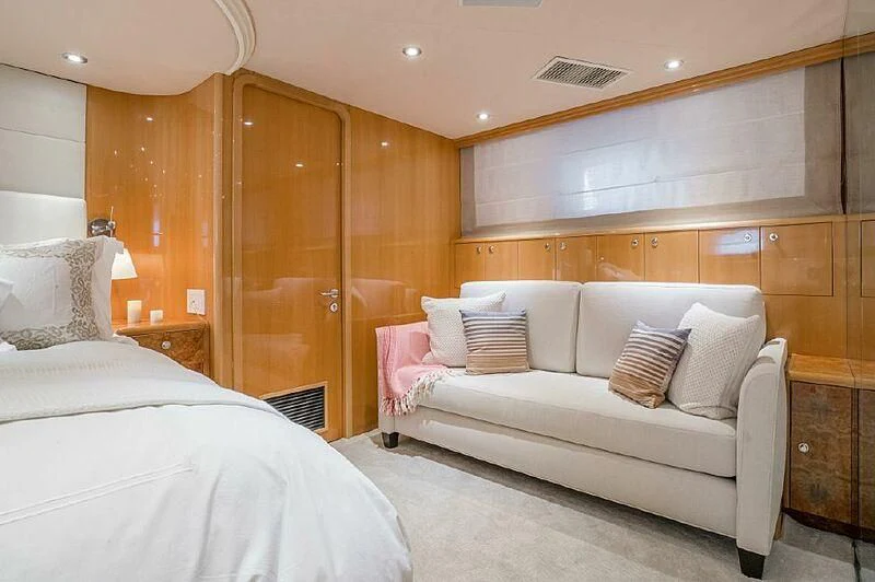 a room with a bed and a couch aboard AKIM Yacht for Sale