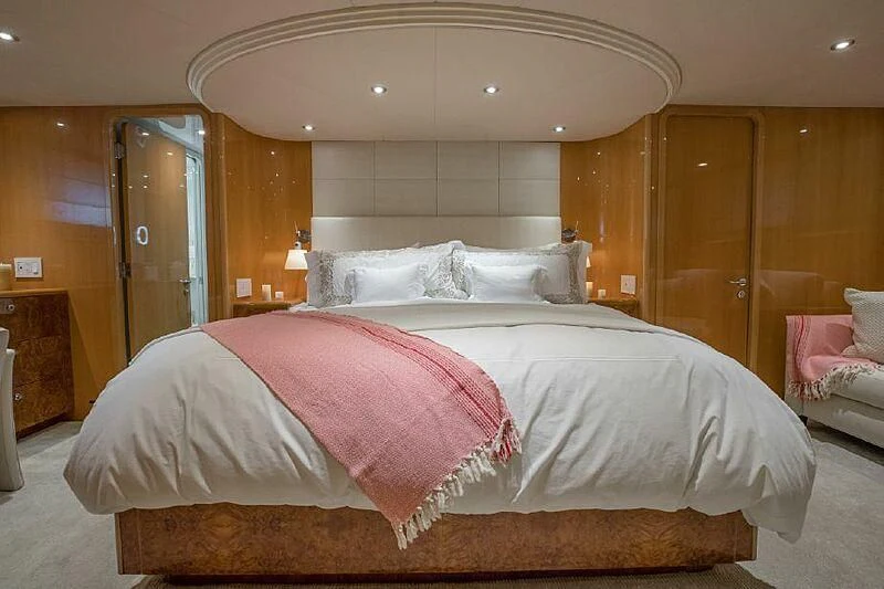 a large bed with pink sheets aboard AKIM Yacht for Sale