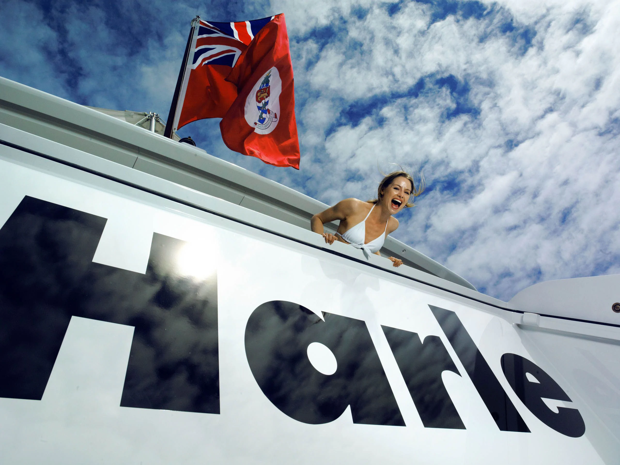 a person on a plane with a flag on the side aboard HARLE Yacht for Sale