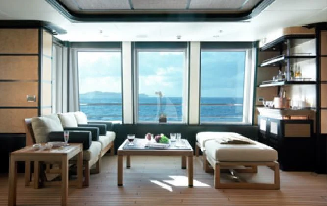 a room with a bed and a table and a window aboard HARLE Yacht for Sale