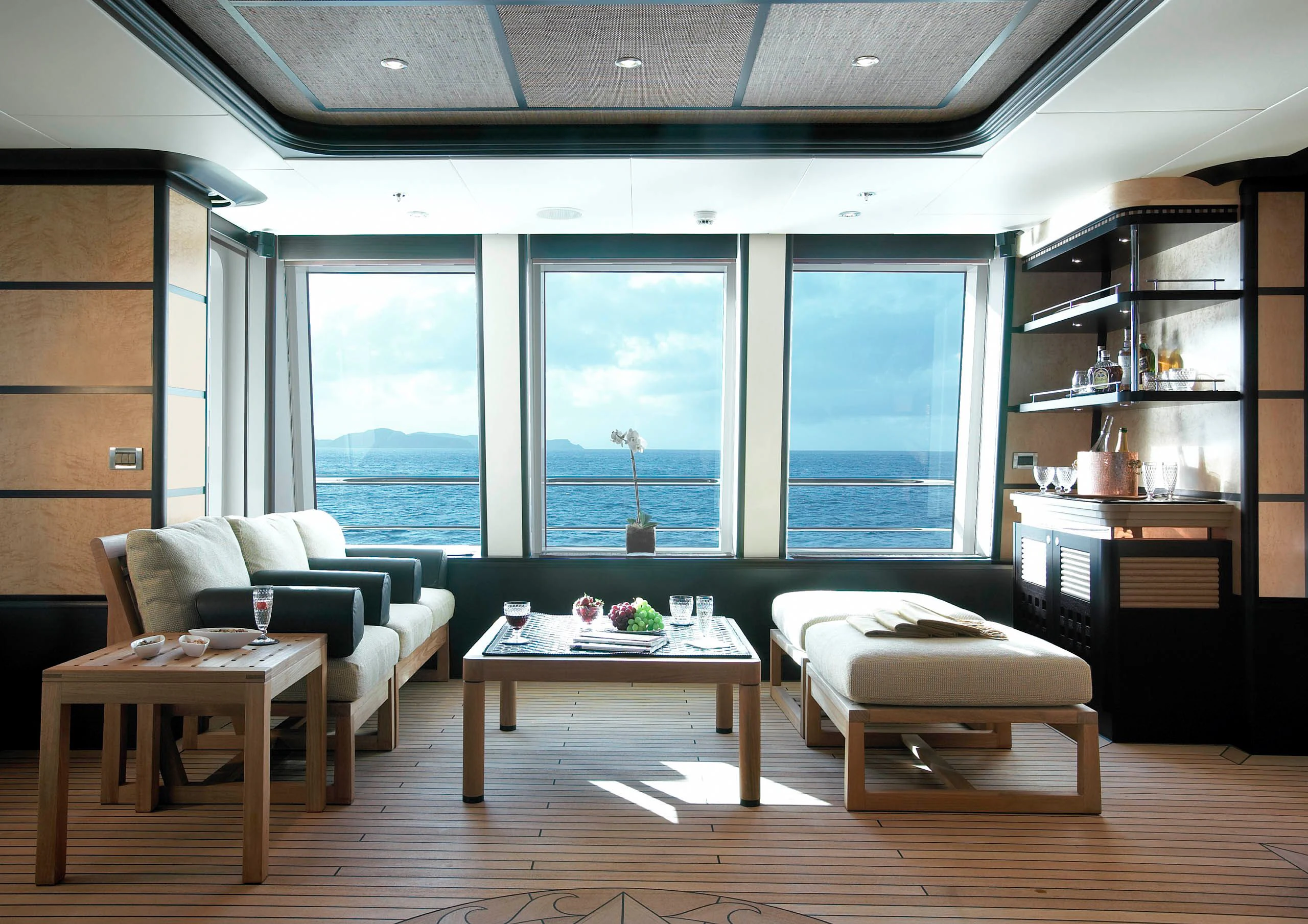 a room with a table and couches aboard HARLE Yacht for Sale