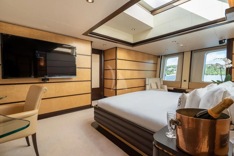 a bedroom with a bed and a television aboard HARLE Yacht for Sale