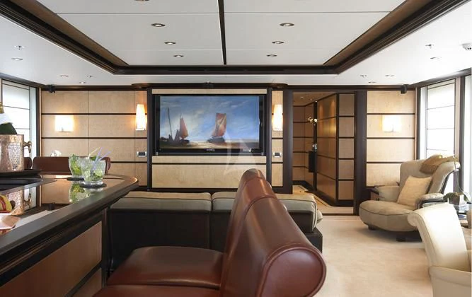 a living room with a tv and furniture aboard HARLE Yacht for Sale