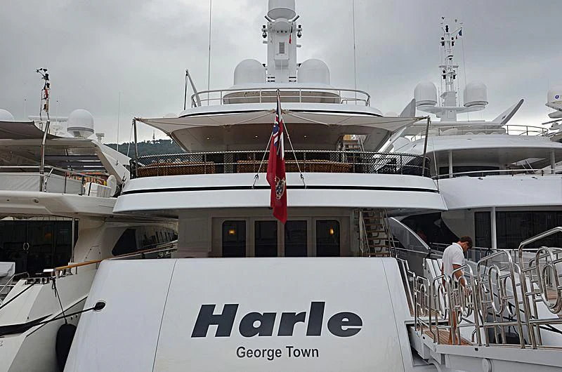 a large white boat with a red flag on the front aboard HARLE Yacht for Sale