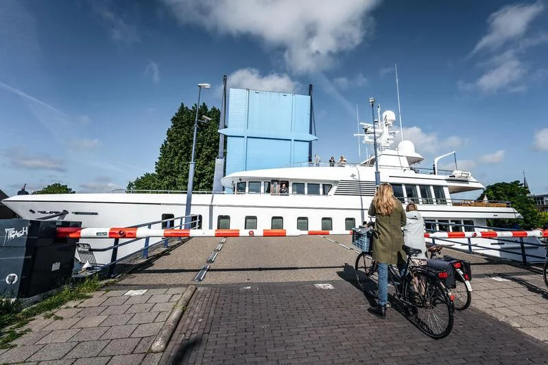 a person on a bicycle next to a boat aboard HARLE Yacht for Sale