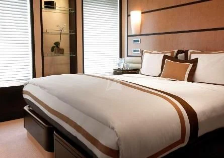 a bed with white sheets aboard HARLE Yacht for Sale