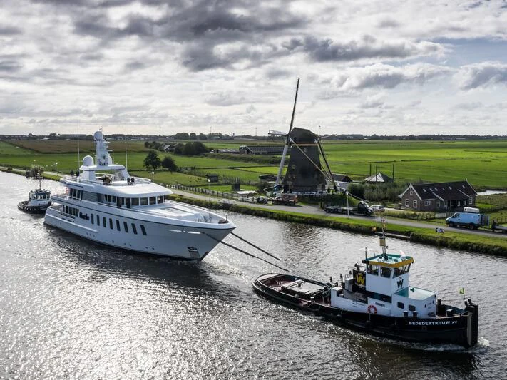 a boat and a barge on a river aboard HARLE Yacht for Sale