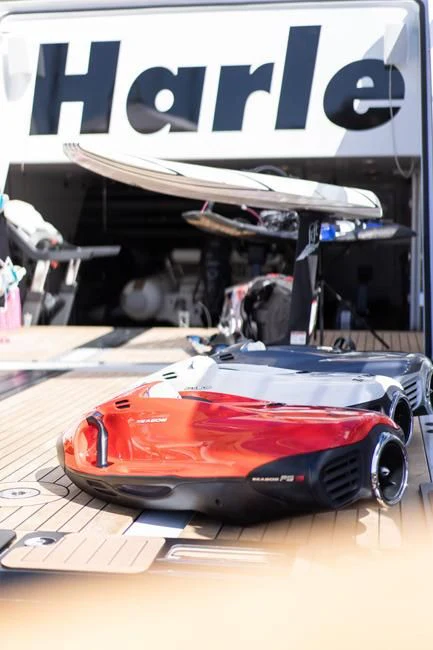 a red sports car on a wooden surface aboard HARLE Yacht for Sale