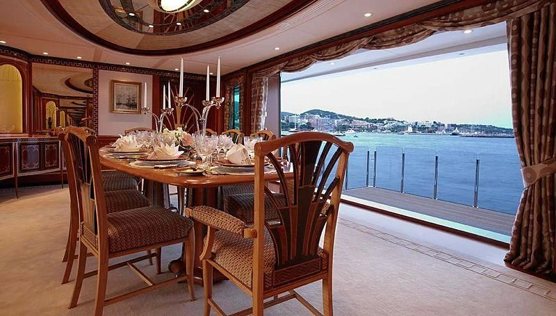 a dining table and chairs on a porch aboard LADY CHRISTINE Yacht for Sale