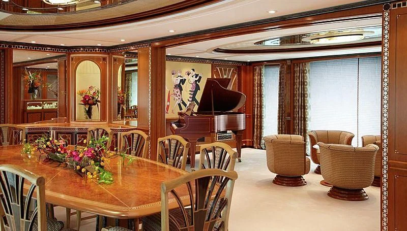 a room with a piano and chairs aboard LADY CHRISTINE Yacht for Sale