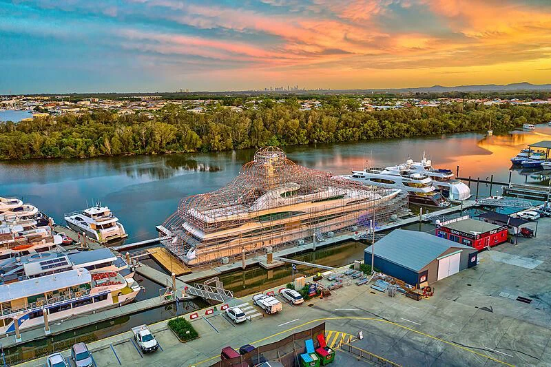 a large building with a body of water in the background aboard LADY CHRISTINE Yacht for Sale