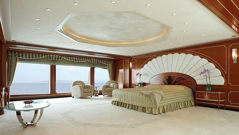 a large bedroom with a large balcony aboard LADY CHRISTINE Yacht for Sale