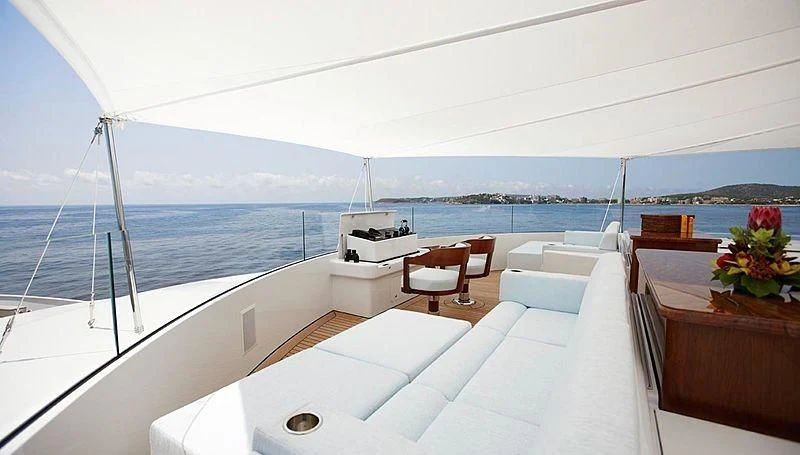 a room with a bed and a table and chairs on a boat aboard LADY CHRISTINE Yacht for Sale