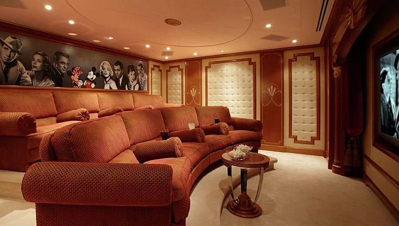 a living room with a large screen aboard LADY CHRISTINE Yacht for Sale