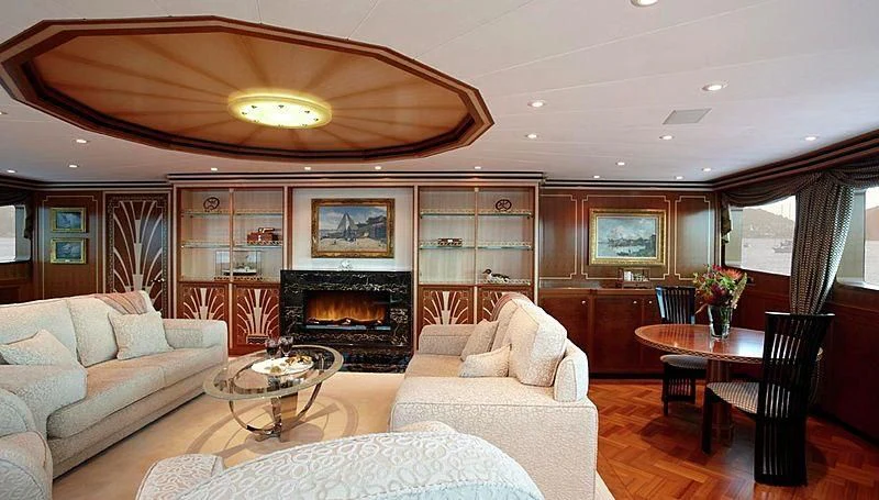 a living room with a fireplace aboard LADY CHRISTINE Yacht for Sale