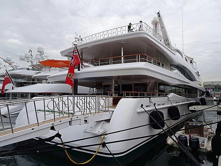 a large white boat with a red stripe on the front aboard LADY CHRISTINE Yacht for Sale