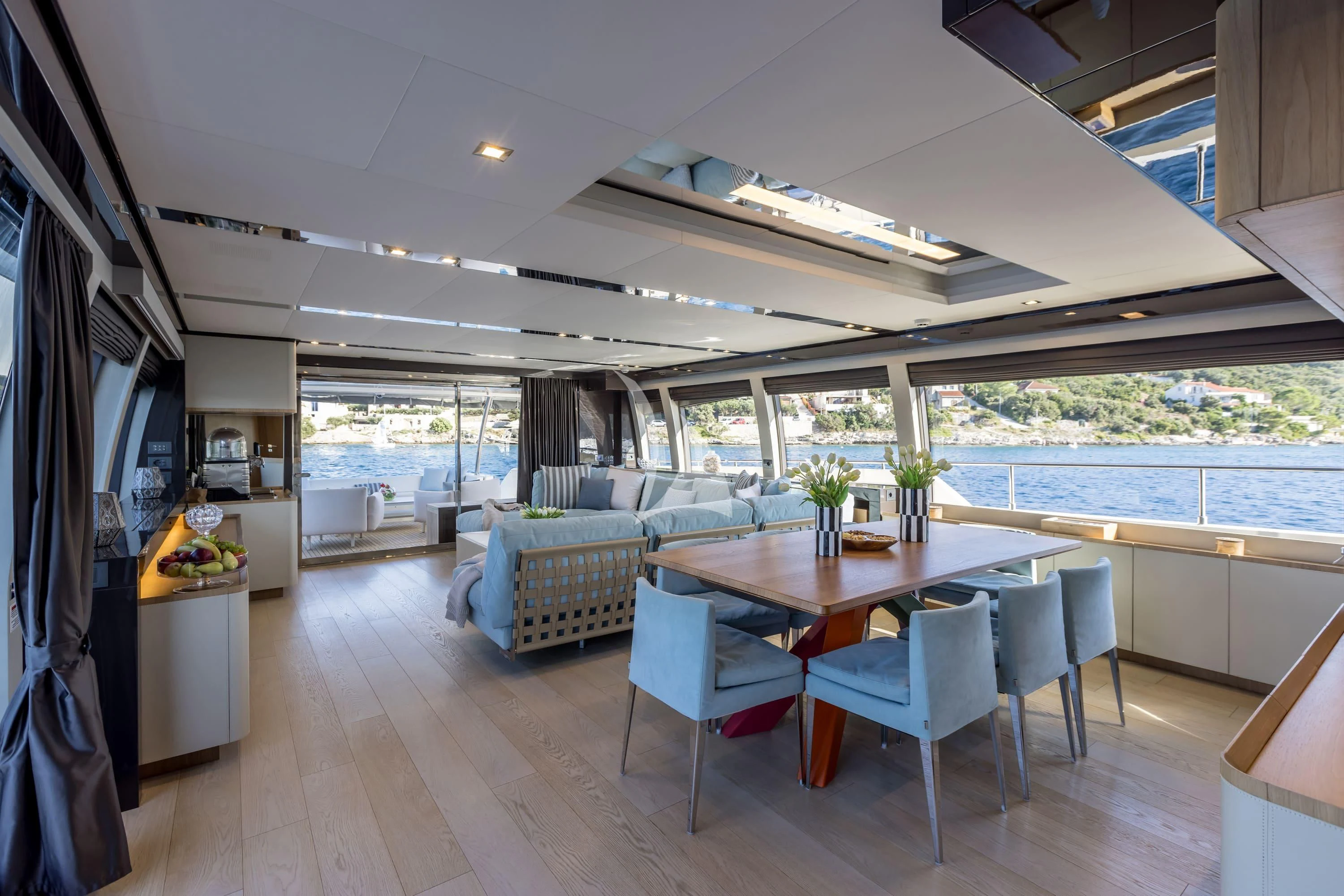 a living room with a table and chairs aboard KATARIINA XO Yacht for Sale