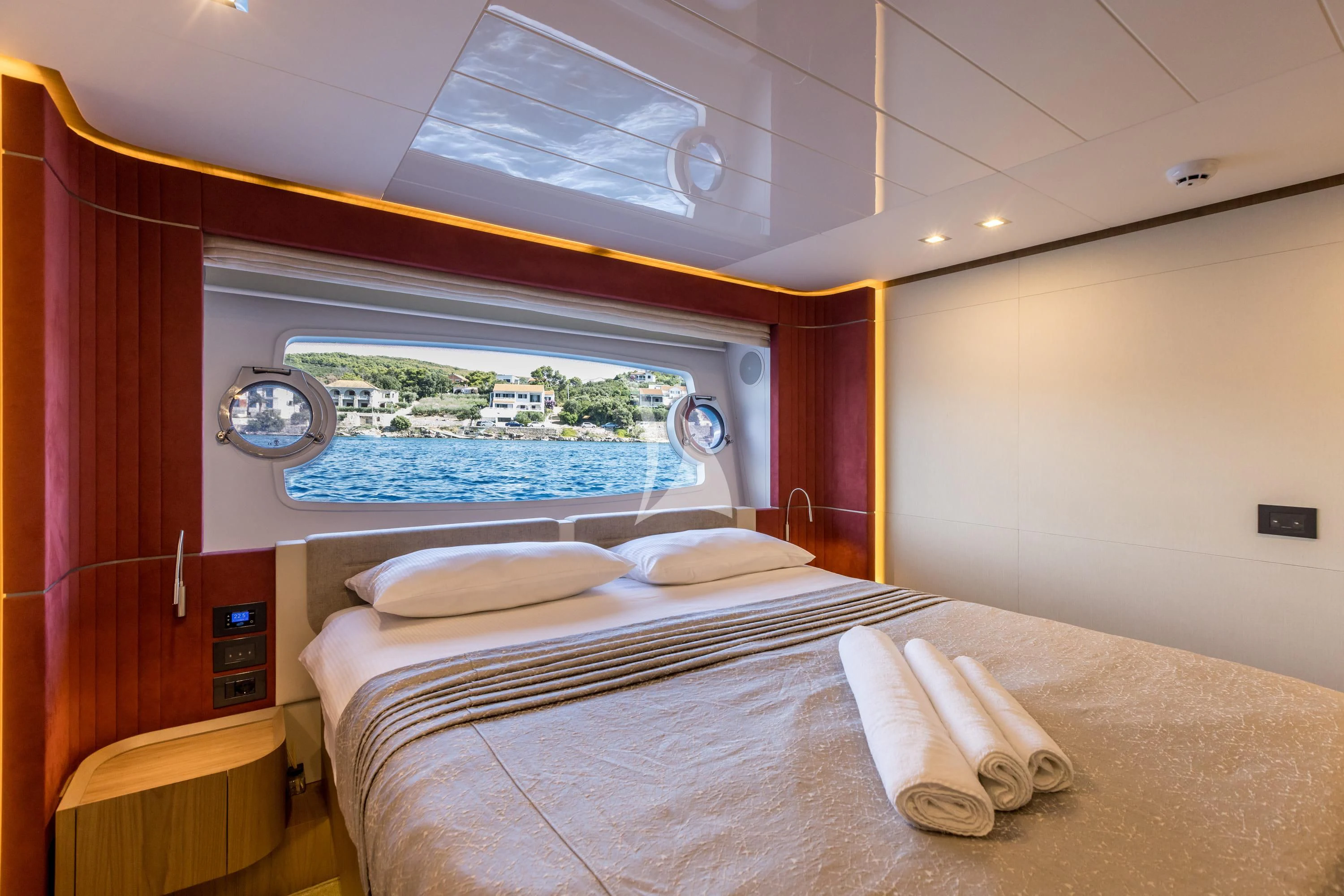 a bed with a large window aboard KATARIINA XO Yacht for Sale