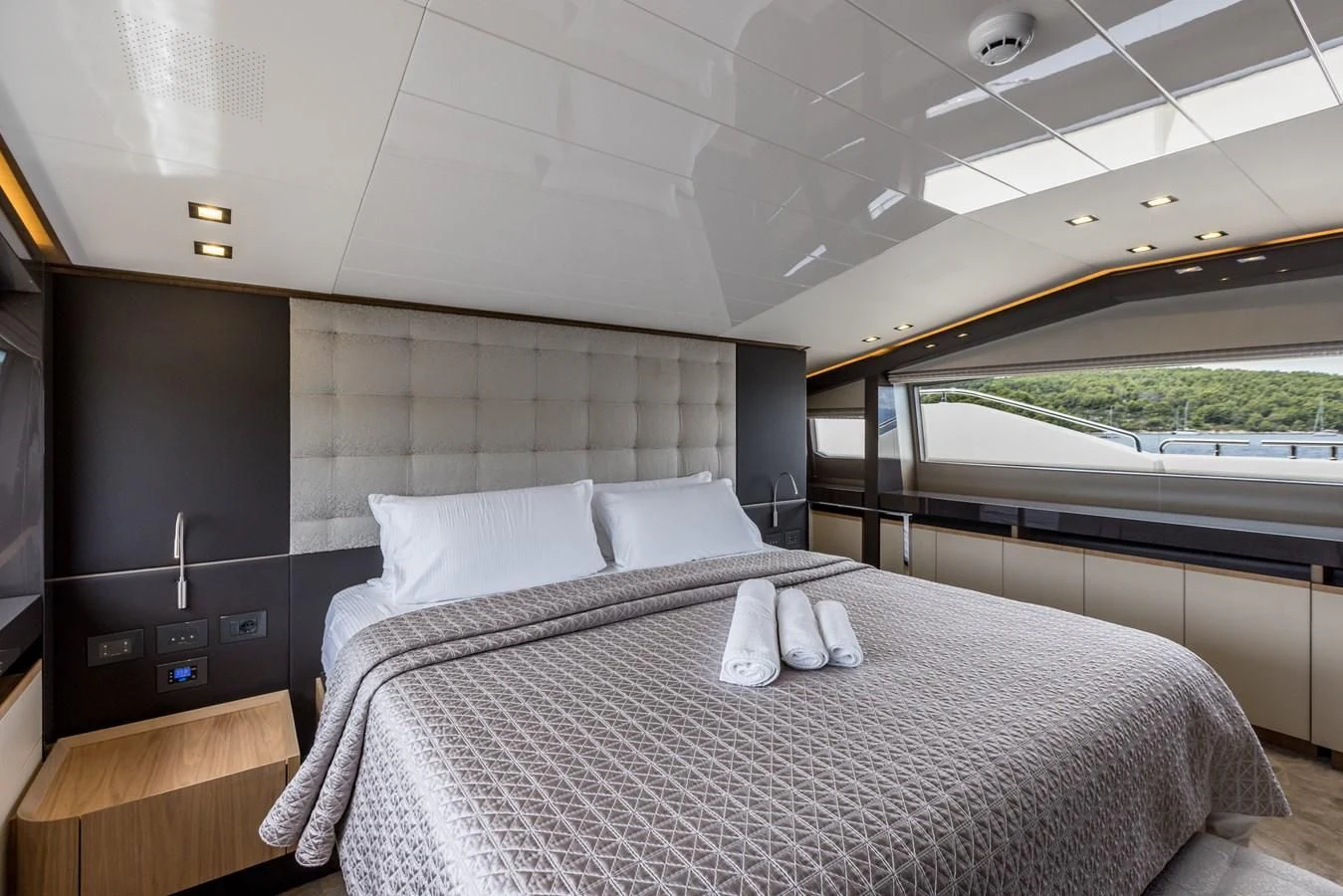 a room with a bed and a window aboard KATARIINA XO Yacht for Sale