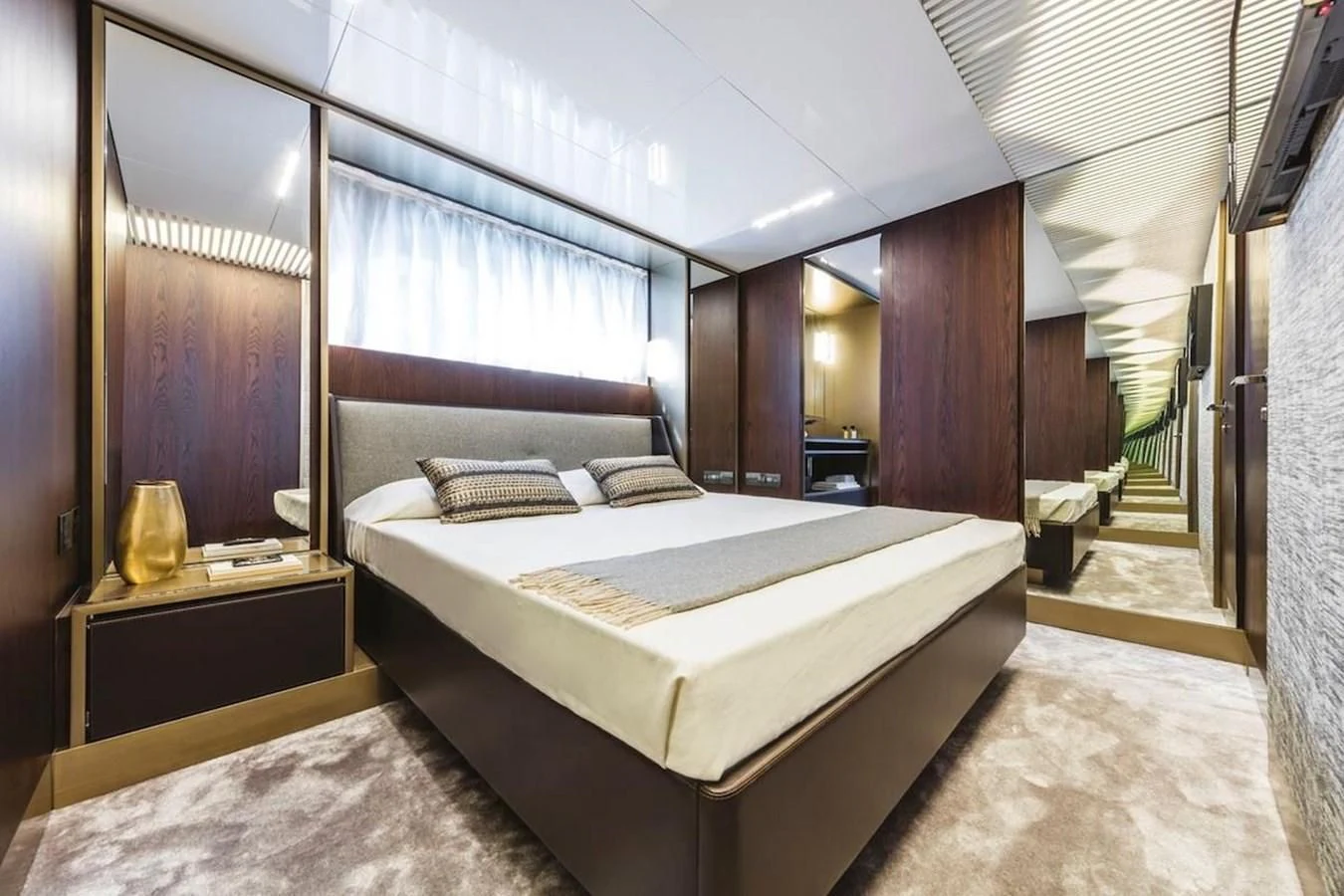a bedroom with a bed and a mirror aboard KATARIINA XO Yacht for Sale