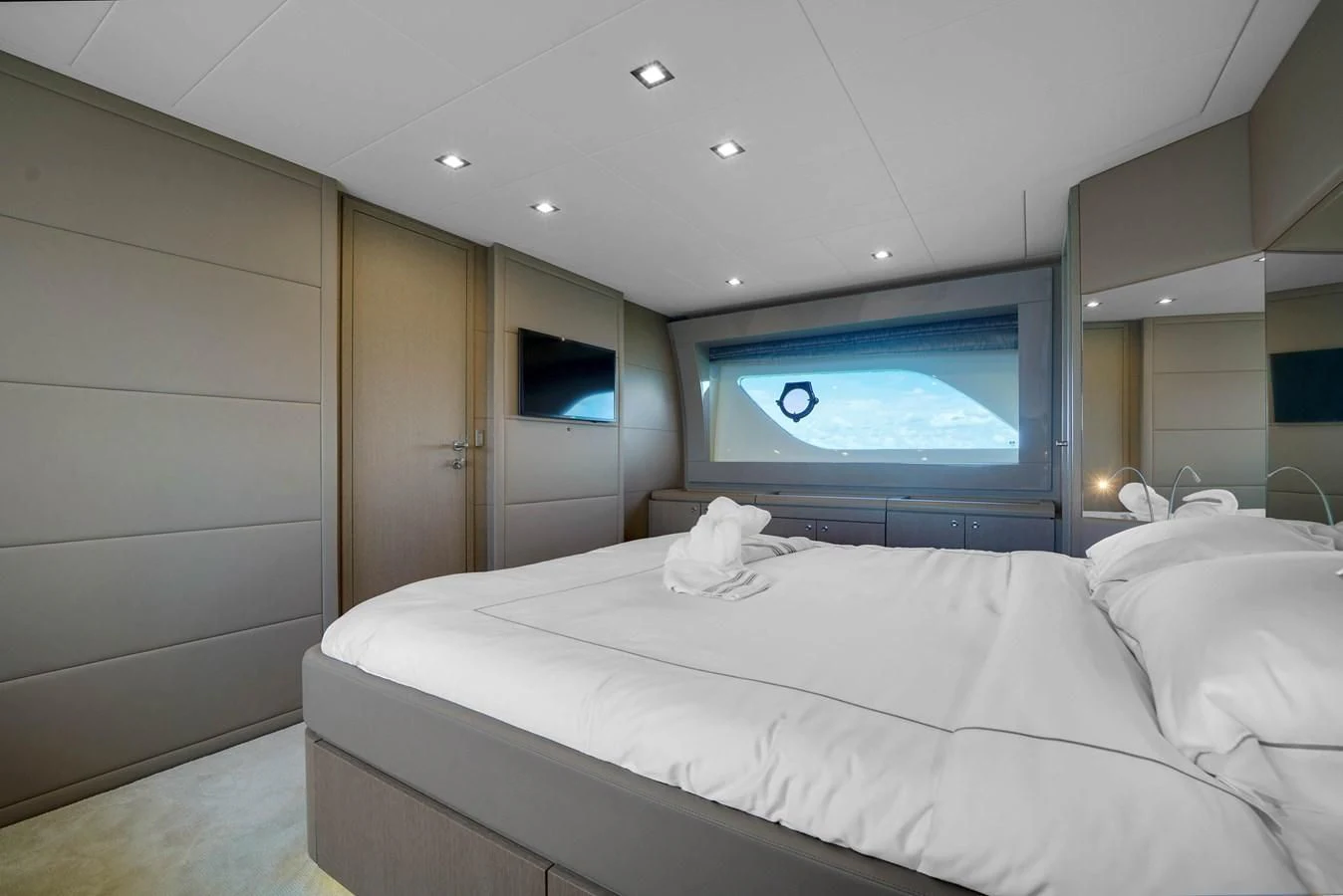 a bedroom with a large television aboard KATARIINA XO Yacht for Sale