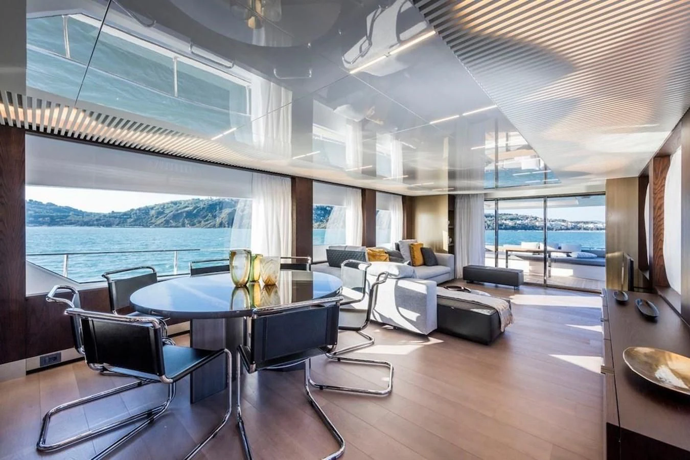 a room with a table chairs and a large window aboard KATARIINA XO Yacht for Sale