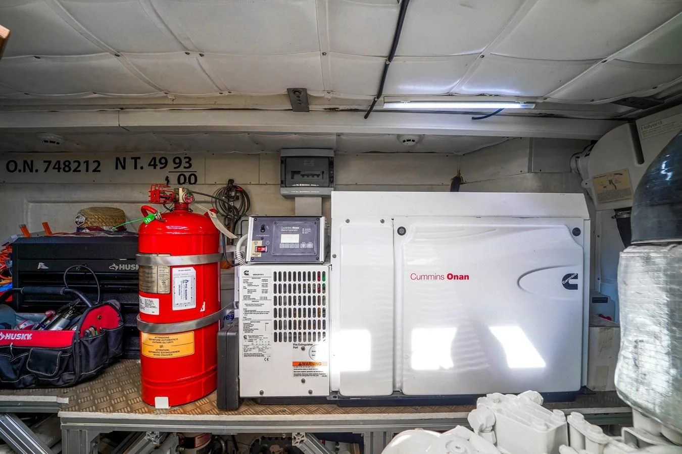 a red and white fire extinguisher in a garage aboard KATARIINA XO Yacht for Sale