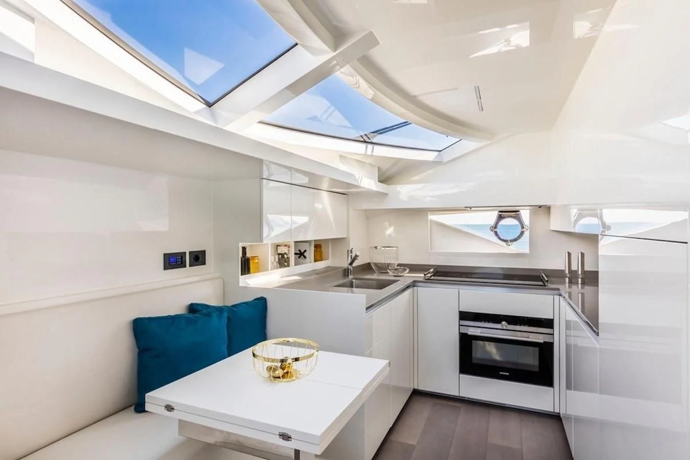 a kitchen with a table and a couch aboard KATARIINA XO Yacht for Sale
