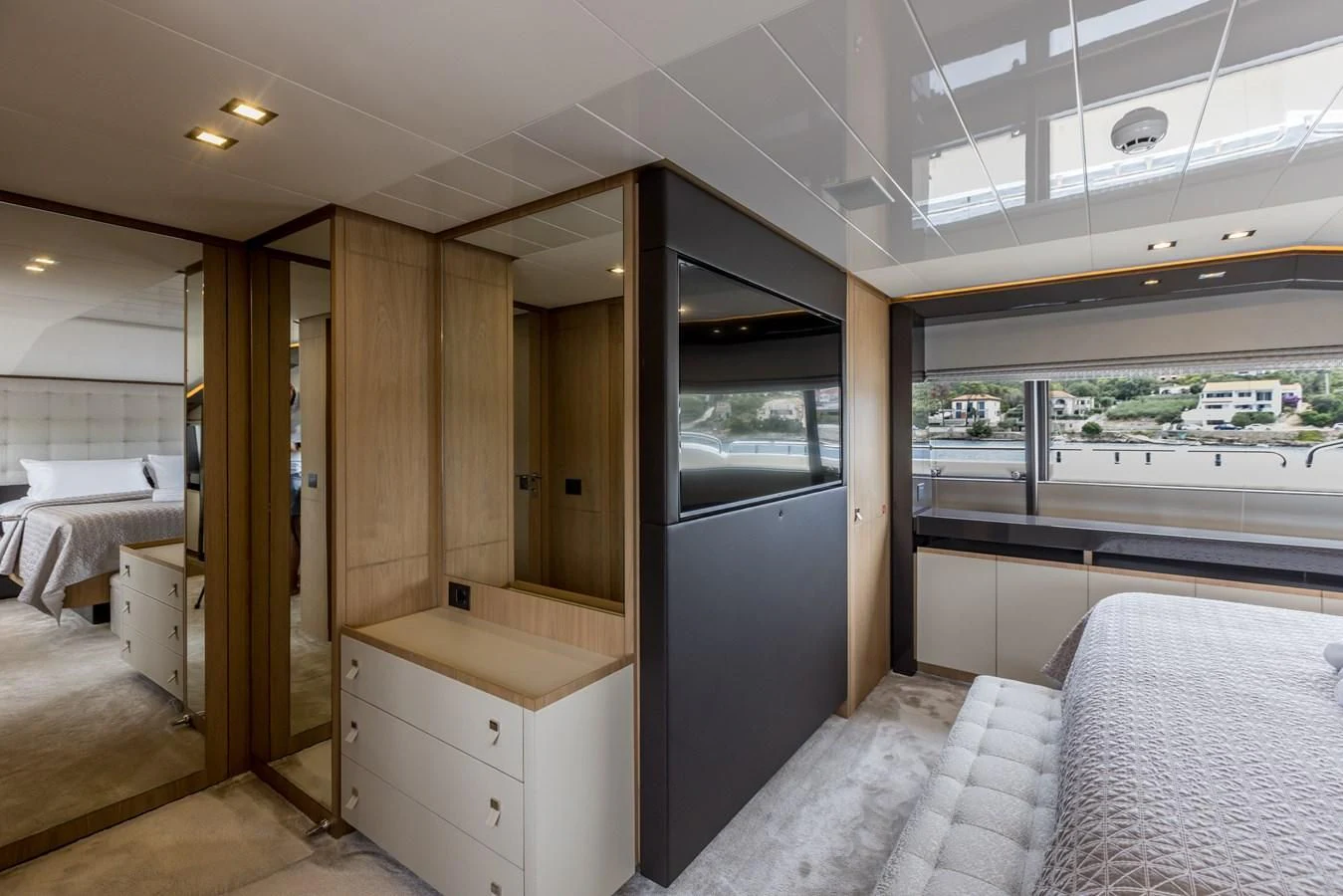 a room with a bed and a large window aboard KATARIINA XO Yacht for Sale