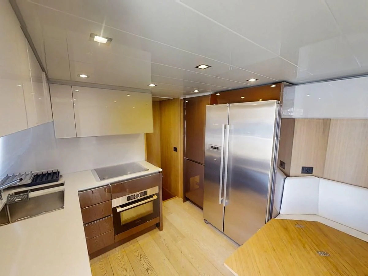 a kitchen with a refrigerator and a stove aboard KATARIINA XO Yacht for Sale