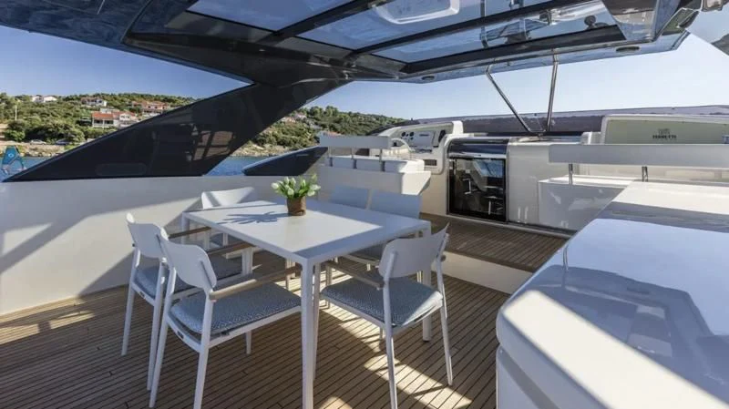 a table and chairs on a deck aboard KATARIINA XO Yacht for Sale