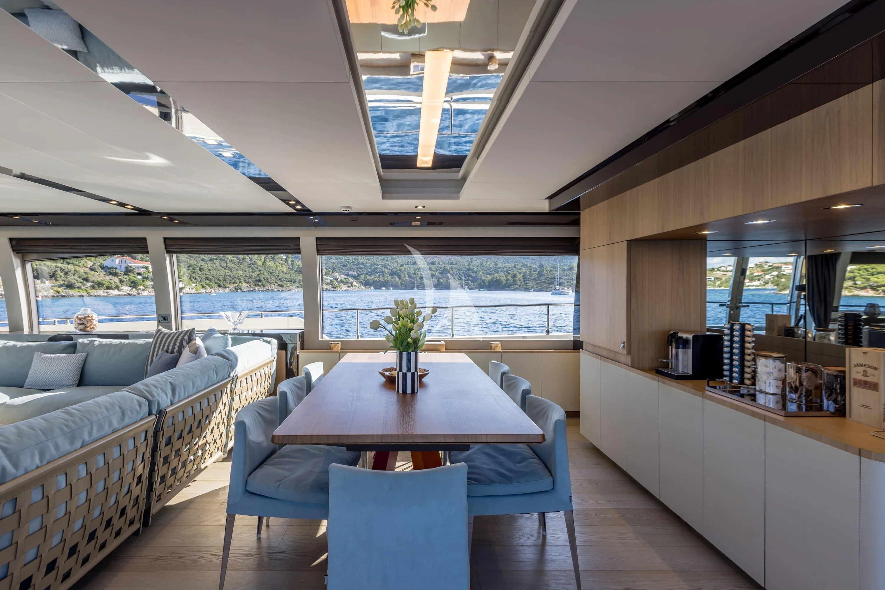 a room with a table and couches aboard KATARIINA XO Yacht for Sale