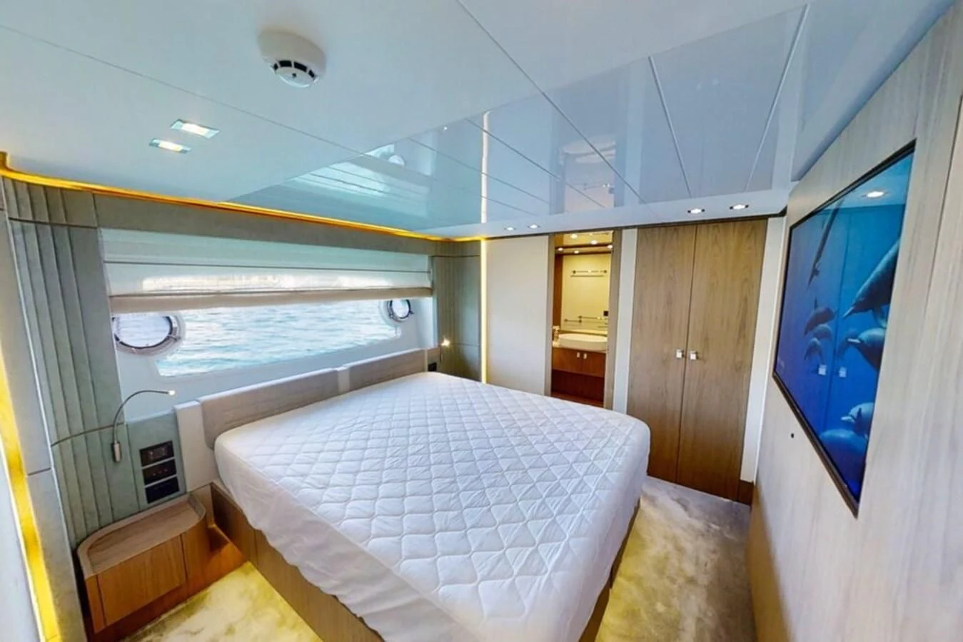 a room with a bed and a window aboard KATARIINA XO Yacht for Sale